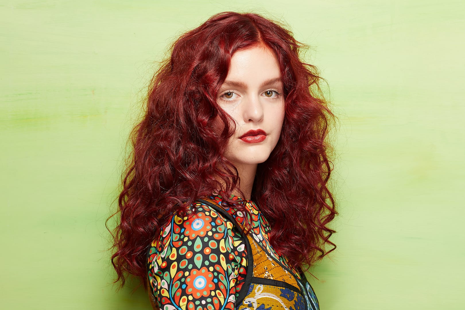 Young woman with curly red colored hair