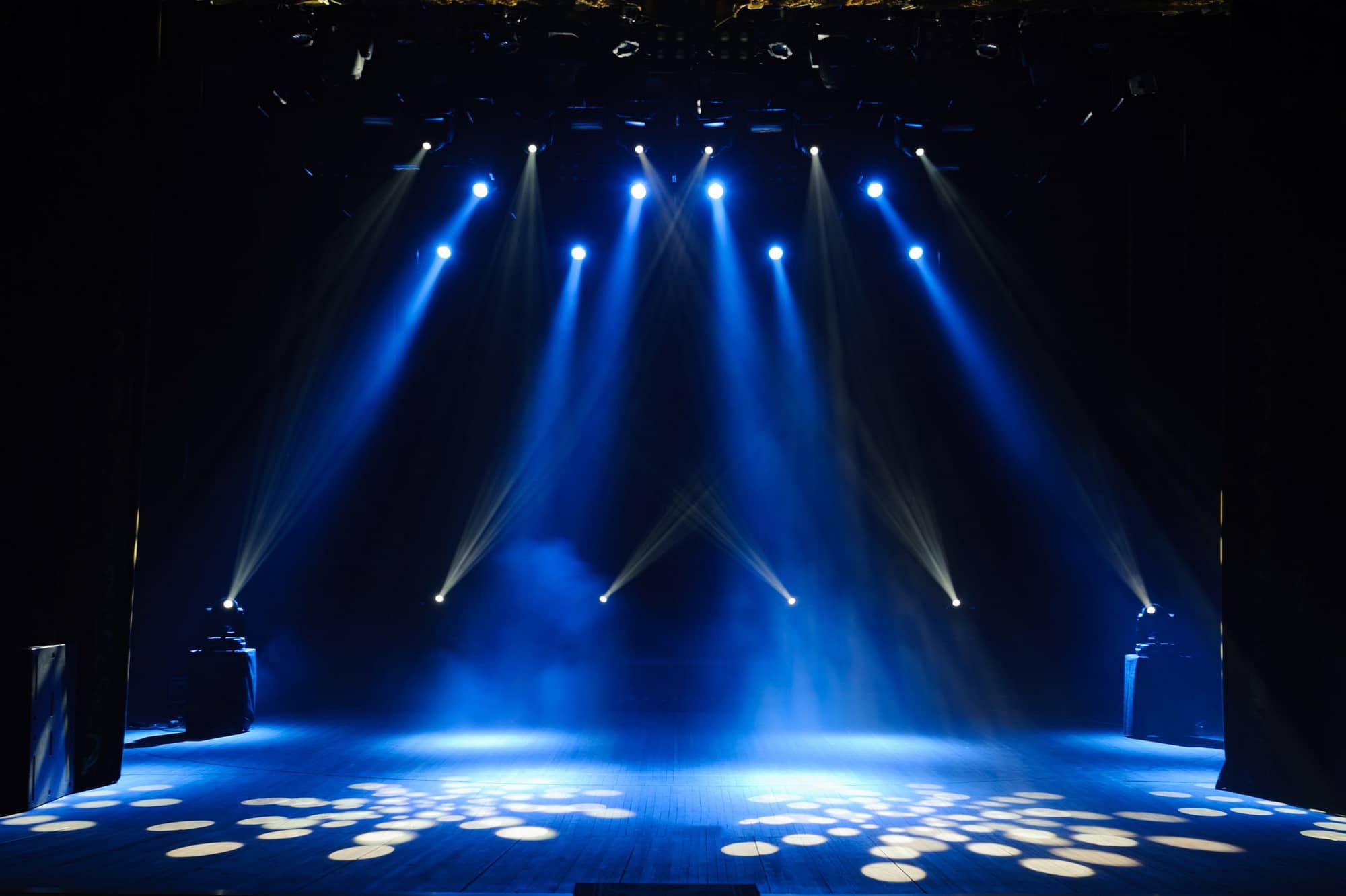 blue and white lights projecting onto a stage