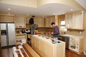 Cabinet installers working on kitchen remodel