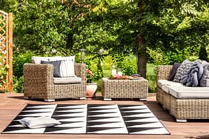 Deck with comfortable furniture and stylish outdoor rug