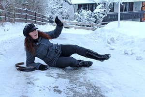 woman falling on an icy driveway