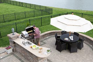 Aerial view of homeowner grilling in outdoor kitchen