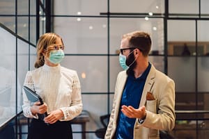 Company employees wearing protective masks at the workplace during Covid-19 outbreak