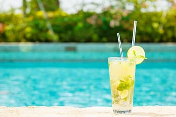 Mojito cocktail at edge of pool