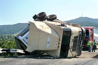 18-wheeler cab flipped on its side on the highway