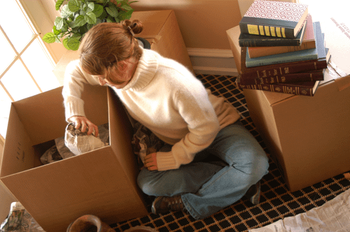 A woman packs storage boxes