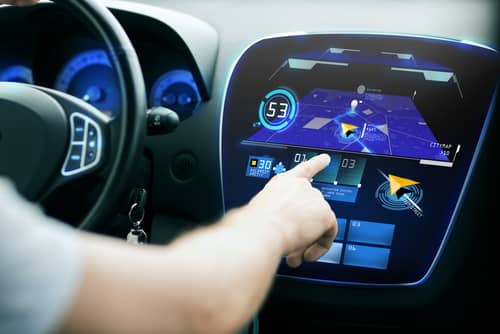 Driver adjusting built-in GPS in car