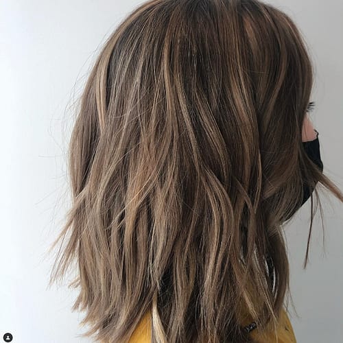Short, warm brown hair with slight wave