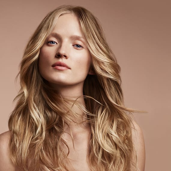 Blonde Aveda Model with tan background