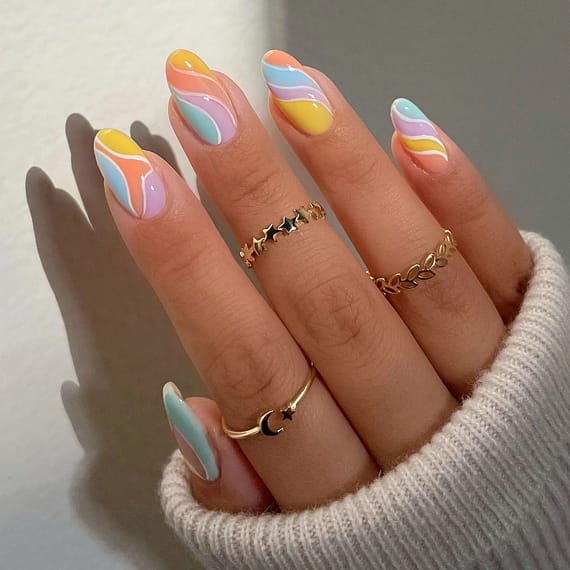 Sherbert Swirls nail trend, brightly colored nails, decorated in a swirl of colors