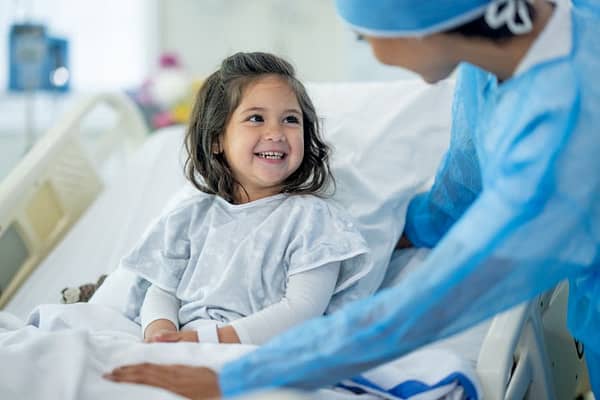 Young child smiles at pediatrician