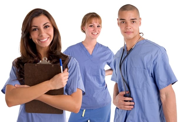 A group of three medical assistants. One is holding a clipboard.