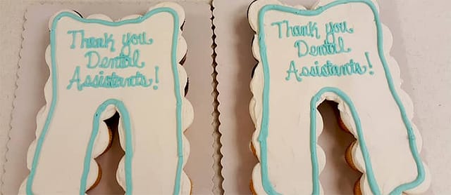 Two cakes in the shape of teeth, decorated as teeth with "Thank You Dental Assistants" written on it. Looking for a Dental Assistant Program in Crystal Lake & Libertyville? Call First Institute today!