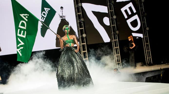 The lead model at the 2016 Aveda earth ay show carrying the aveda flag