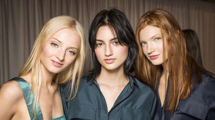Three aveda hair models with different hair colors