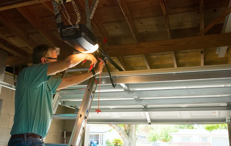 A technician repairs a home garage door.
