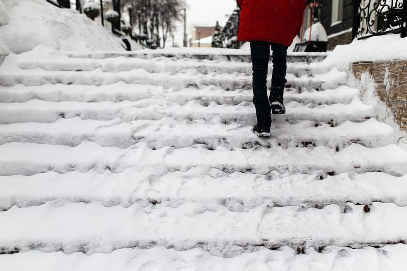 woman walking on steps with ice