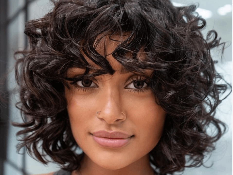 Beautiful brunette with curly shaggy bob haircut