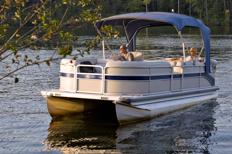 two-men-driving-pontoon-boat-on-lake