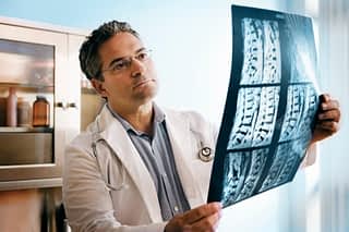 Doctor examines X-rays of spine