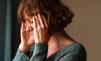 Woman experiencing a migraine