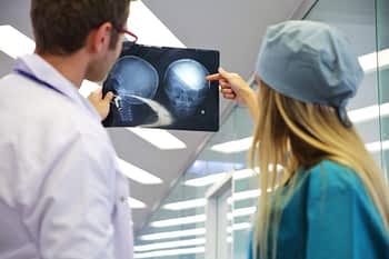 Doctors examine X-ray of brain
